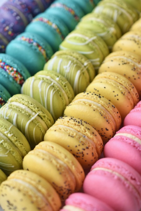 A colorful assortment of French macarons featuring: cake batter, key lime white chocolate, lemon poppyseed, and jasmine.