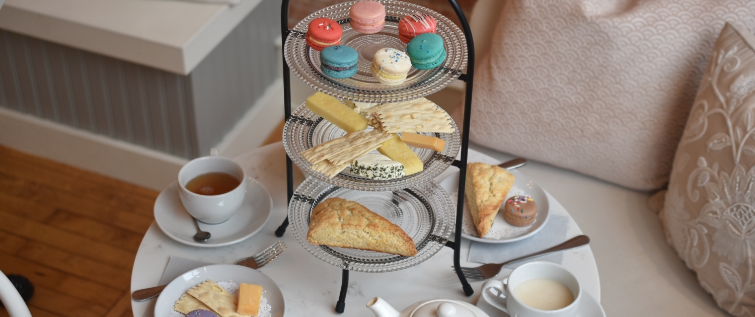 Afternoon Tea at Le Bon Macaron including fresh scones, cheese, a pot of tea and French macarons.