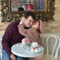 Little girl giving her dad a kiss on the cheek at Le Bon Macaron in Michigan