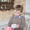 Little boy drinking a kiddie cappuccino at Le Bon Macaron in Holland Michigan
