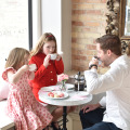 Father and daughters enjoying tea and hot chocolate at Le Bon Macaron in Grand Rapids Michigan for Valentine's Day