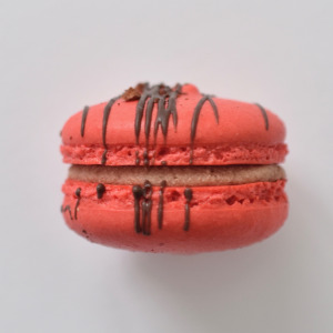 Chocolate raspberry French macaron featuring red macarons shells filled with a chocolate ganache raspberry jam buttercream.