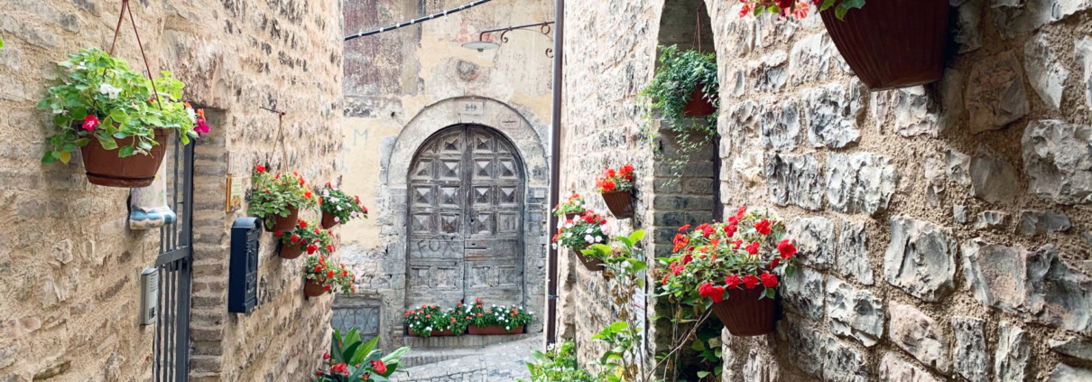 Cobblestone streets in Spello filled with flowers