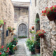 Cobblestone streets in Spello filled with flowers